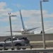 United Flight 169 Boeing 767 flying low over New Jersey Turnpike highway traffic and light poles on final approach to Newark Liberty International Airport.