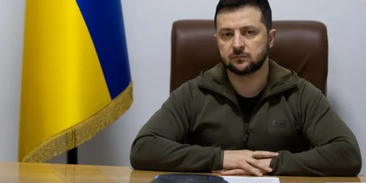 Ukrainian President Volodymyr Zelenskyy seated at a desk with the Ukrainian flag behind him, addressing the Romanian Parliament amid the EU associate membership dispute.