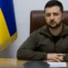 Ukrainian President Volodymyr Zelenskyy seated at a desk with the Ukrainian flag behind him, addressing the Romanian Parliament amid the EU associate membership dispute.