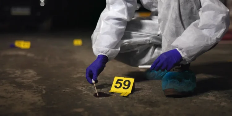St Lucia national killed — illustrative image of forensic investigator collecting evidence at night crime scene