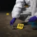 St Lucia national killed — illustrative image of forensic investigator collecting evidence at night crime scene