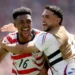 United States Advances to the World Cup knockout stage as USA players celebrate their 2-0 win over Australia in Seattle.