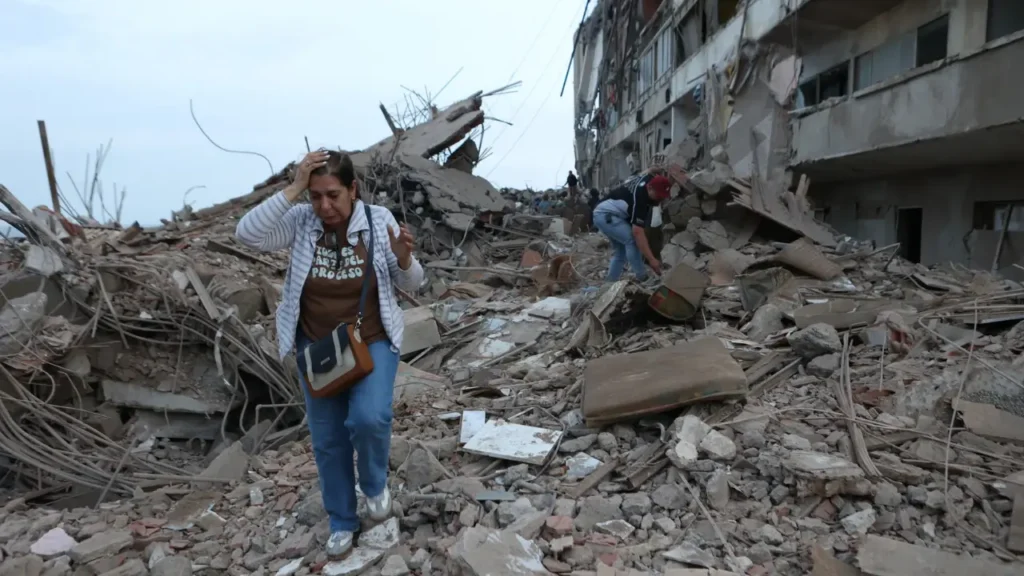 Venezuela earthquake residents walk through rubble of damaged buildings in Catia La Mar June 25 2026