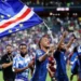 Cabo Verde players and staff celebrate on the field after qualifying for the World Cup 2026 Round of 32.