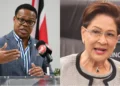 Dr. Amery Browne speaking at a podium beside Prime Minister Kamla Persad-Bissessar in Caricom Barnett row image.