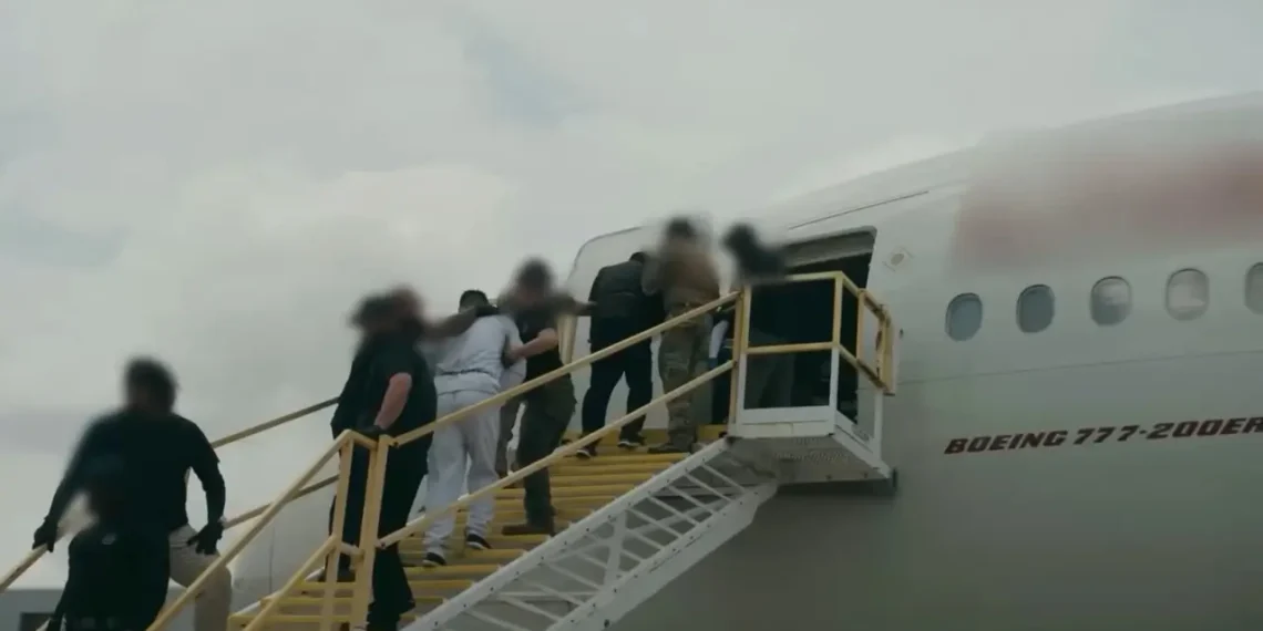 ndividuals in restraints board a Boeing 777 aircraft via a mobile staircase, in a file image illustrating the type of removal flight at the center of the Antigua deportee costs dispute