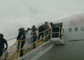ndividuals in restraints board a Boeing 777 aircraft via a mobile staircase, in a file image illustrating the type of removal flight at the center of the Antigua deportee costs dispute