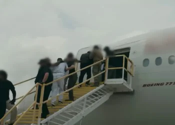 ndividuals in restraints board a Boeing 777 aircraft via a mobile staircase, in a file image illustrating the type of removal flight at the center of the Antigua deportee costs dispute