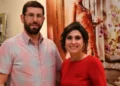 The Hadeeds, Dominic and Genevieve, standing together indoors and smiling for a photo.