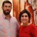 The Hadeeds, Dominic and Genevieve, standing together indoors and smiling for a photo.