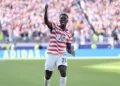 USMNT forward Folarin Balogun celebrating a goal in a US jersey during the 2026 World Cup.