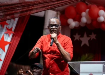 Prime Minister Philip J. Pierre, wearing a red shirt, addresses supporters during Five Years of SLP Rule in Saint Lucia.