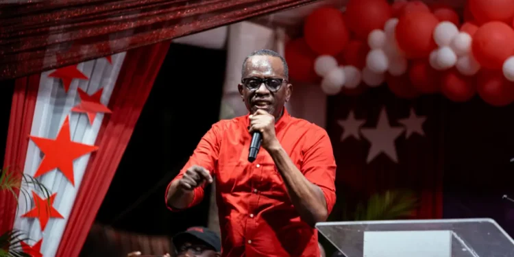 Prime Minister Philip J. Pierre, wearing a red shirt, addresses supporters during Five Years of SLP Rule in Saint Lucia.