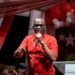Prime Minister Philip J. Pierre, wearing a red shirt, addresses supporters during Five Years of SLP Rule in Saint Lucia.
