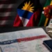 US visa bond program image showing a US visa, passport, cash and Caribbean flags.