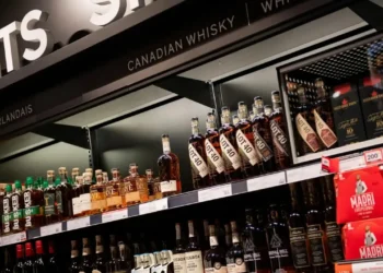 Canadian whisky bottles on store shelves, illustrating the US ban on Canadian imports.