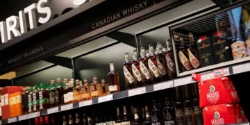 Canadian whisky bottles on store shelves, illustrating the US ban on Canadian imports.
