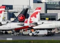 Multiple Air Canada aircraft parked at an airport terminal, illustrating the cancellation of Air Canada South Carolina flights.