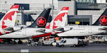 Multiple Air Canada aircraft parked at an airport terminal, illustrating the cancellation of Air Canada South Carolina flights.