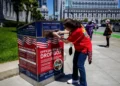 Voter deposits a ballot into an official San Francisco drop box, illustrating the California ballot ruling dispute.